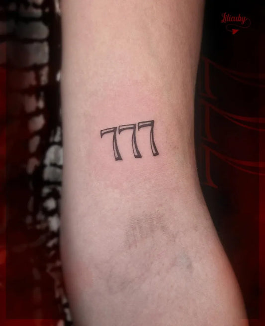 Small Blackwork 777 Tattoo on Women Arm by @lilicuby