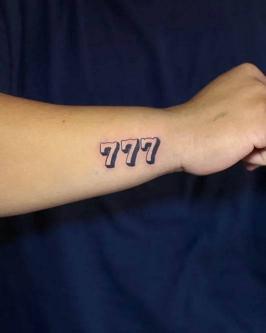 Small Blackwork 777 Tattoo on Women Forearm by @valen_ink9