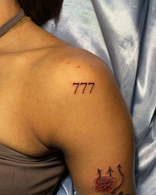 Small Blackwork 777 Tattoo on Women Shoulder by @tricya.fineline