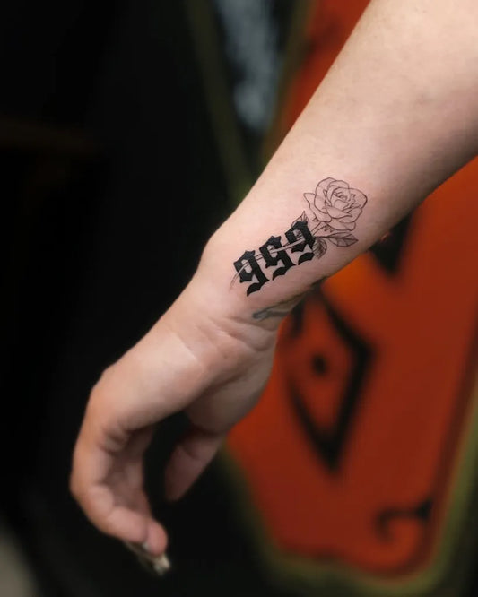 Small Blackwork 999 and Rose Tattoo on Women Wrist by @blackblossomtattoos