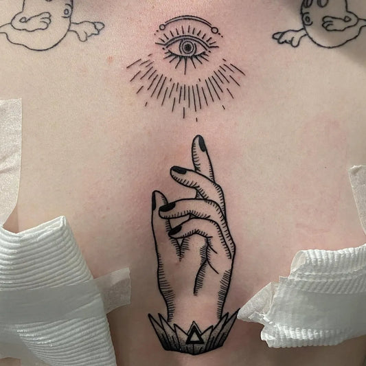 Small Blackwork All Seeing Eye Hand with Triangle on Women Sternum Tattoo by @liezylblairtattoos