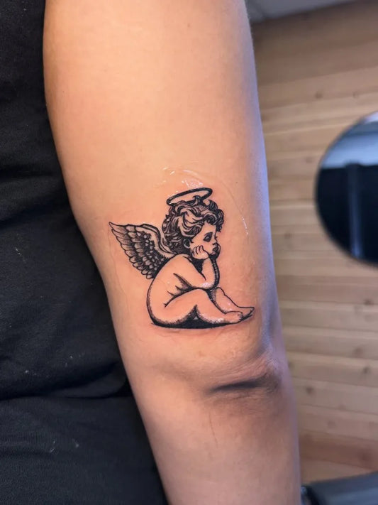 Small Blackwork Angel on Women Arm Tattoo by @stizzls.tats