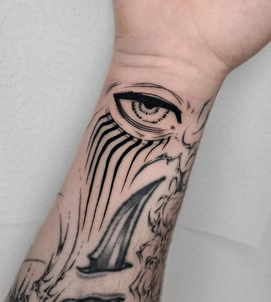 Small Blackwork Anime Eye on Men Wrist Tattoo by @agusto.jpg
