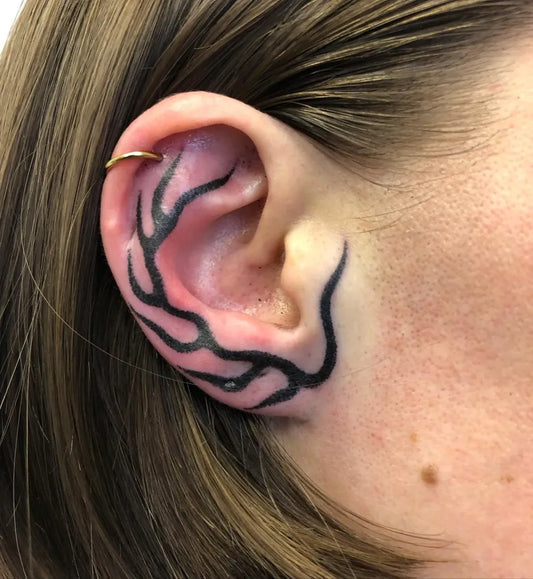 Small Blackwork Antler Tattoo on Women Behind the Ear by @indyvoet