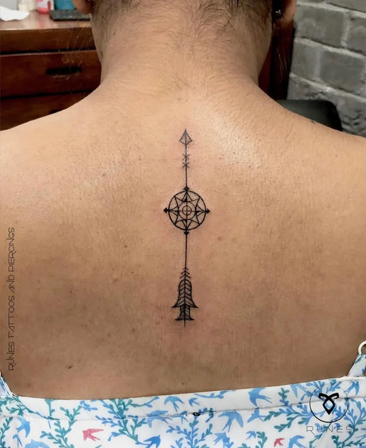 Small Blackwork Arrow and Compass Tattoo on Women Back by @runes_tattoos_official