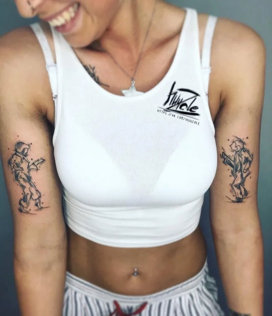 Small Blackwork Astronauts Tattoo on Women Upper Arm by @velik.cy