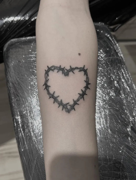 Small Blackwork Barbed Heart on Women Arm Tattoo by @bartolo_old_b
