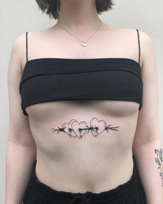 Small Blackwork Barbed Wire Hearts Tattoo on Women Stomach by @armin.agne