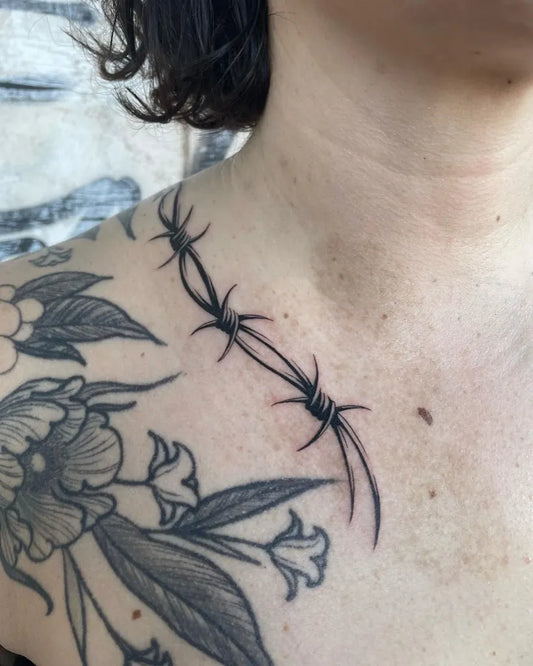 Small Blackwork BarbedWireAndFlower Tattoo on Women Collarbone by @loz_tattooer