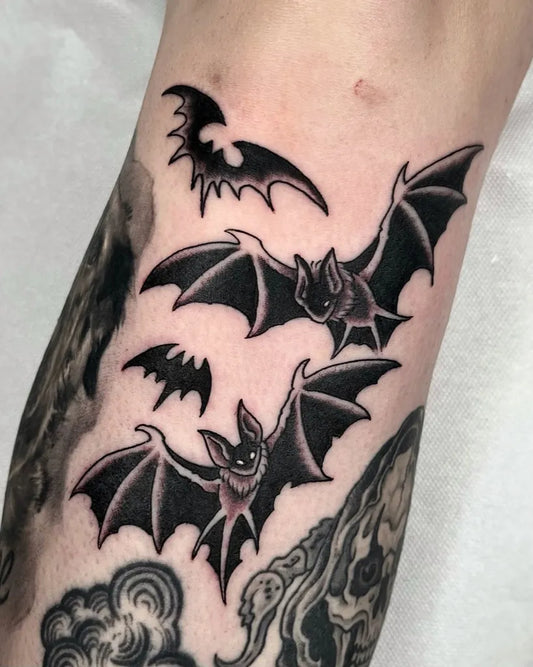 Small Blackwork Bats Tattoo on Women Arm by @angelxgrim