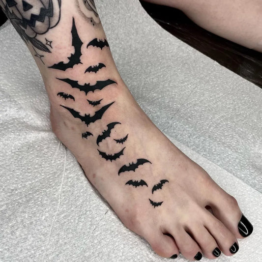 Small Blackwork Bats Tattoo on Women Foot by @caseymarietattoo