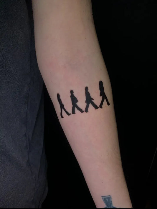 Small Blackwork Beatles Silhouettes Music Tattoo on Women Arm by @lauraink11