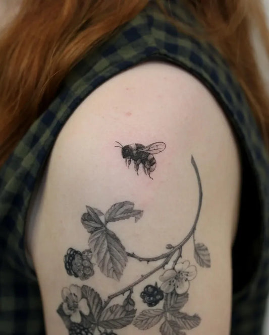 Small Blackwork Bee Blackberry Branch on Women Upper Arm Tattoo by @kyla_rose_tattoo