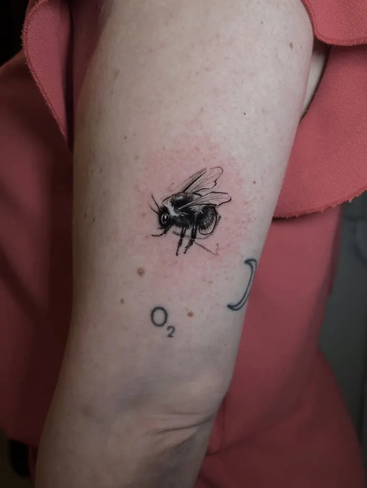 Small Blackwork Bee O2 on Women Arm Tattoo by @kaname.ink