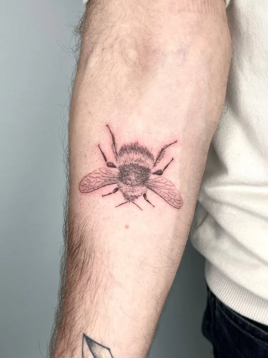 Small Blackwork Bee Tattoo on Men Arm by @tattooaurax