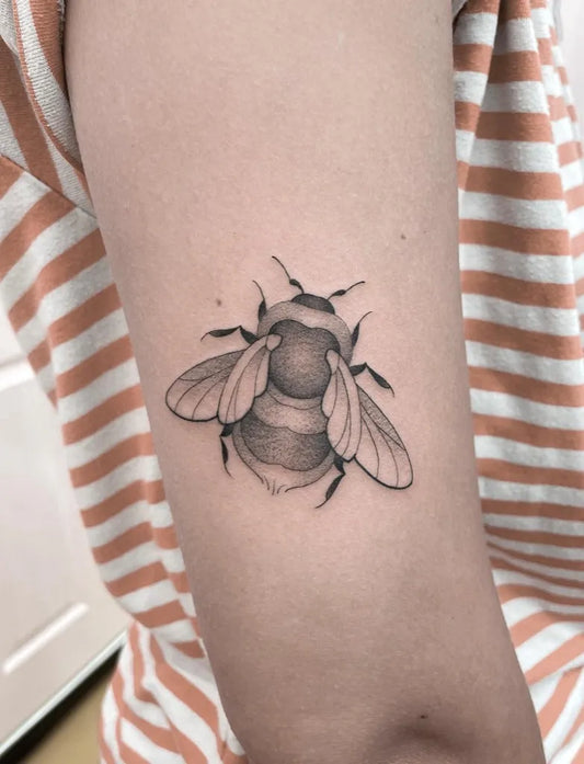Small Blackwork Bee on Women Arm Tattoo by @jadeharristattoo