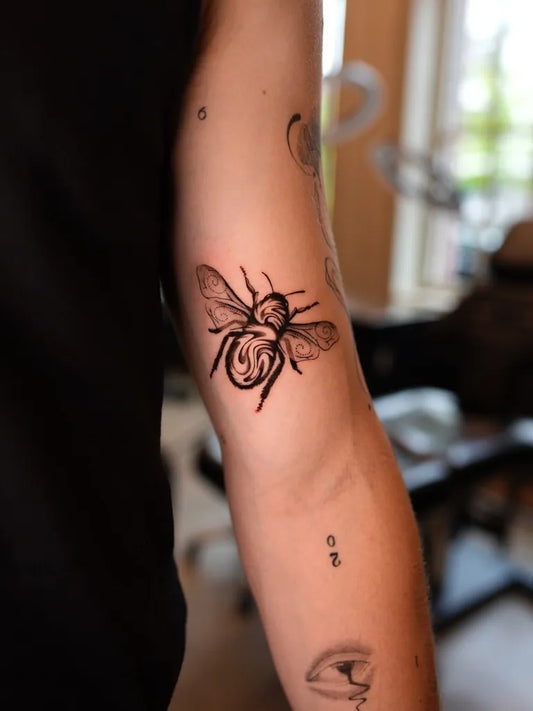Small Blackwork Bee on Women Arm Tattoo by @lisa_pah