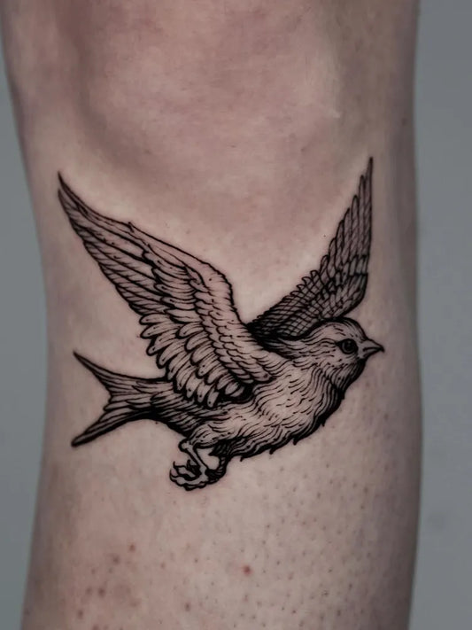 Small Blackwork Bird Tattoo on Women Arm by @vox.maeot
