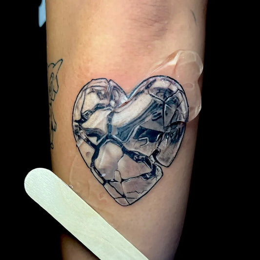 Small Blackwork Broken Heart on Women Arm Tattoo by @tattoosbyeo