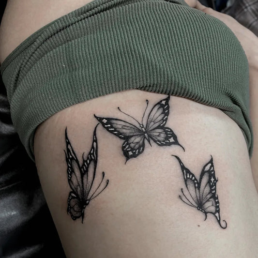 Small Blackwork Butterflies Tattoo on Women Rib by @chucky_tattoos