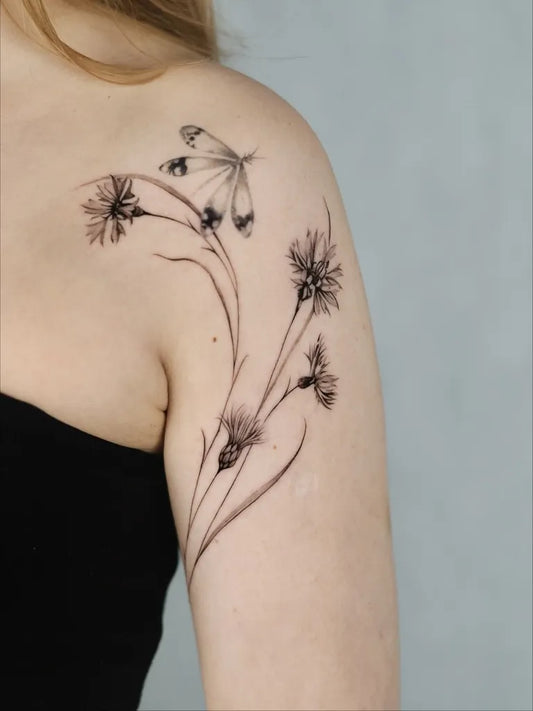 Small Blackwork Butterfly Thistle on Women Shoulder Flower Tattoo by @szyna.ink