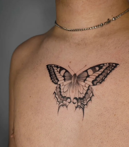 Small Blackwork Butterfly on Men Sternum Tattoo by @tattoosby_elise
