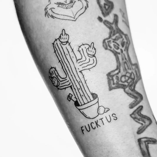 Small Blackwork Cactus with Middle Finger and Fucketus Tattoo on Men Arm by @vato.ink
