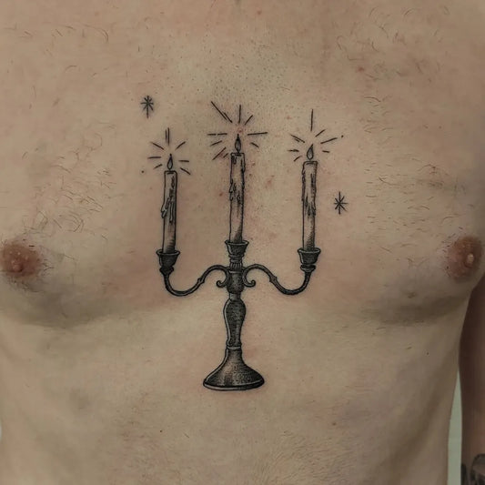Small Blackwork Candlestick on Men Sternum Tattoo by @alexrobinsontattoo