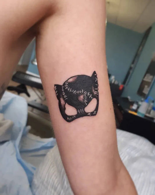 Small Blackwork Cat Mask Tattoo on Men Bicep by @tj_tattoos99