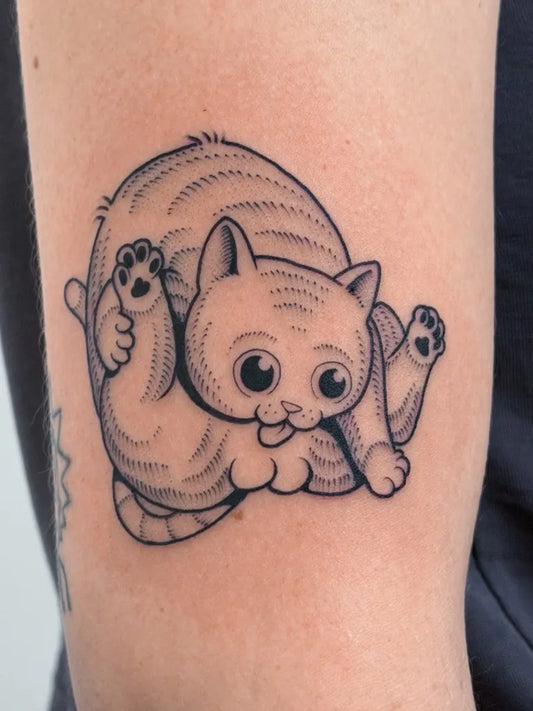Small Blackwork Cat Tattoo on Women Arm by @sad_cid