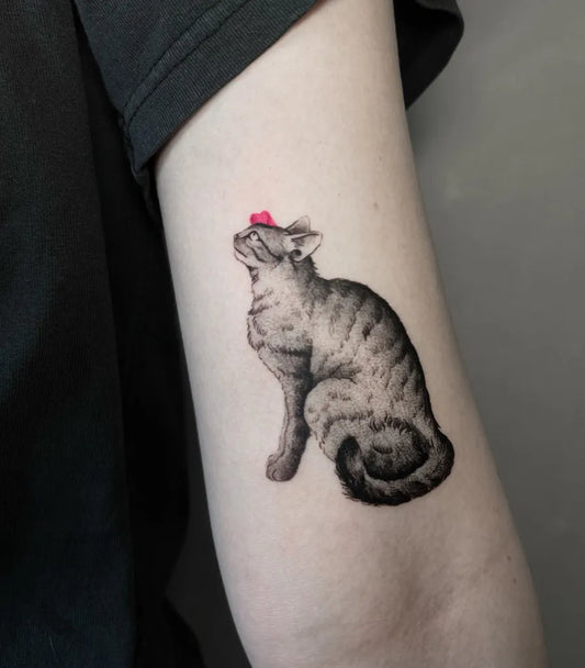 Small Blackwork Cat with Red Nose Tattoo on Women Arm by @melty.pokes