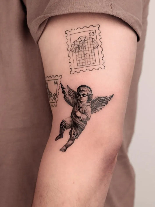 Small Blackwork Cherub Stamp Tattoo on Men Arm by @viktoria.wagenhals