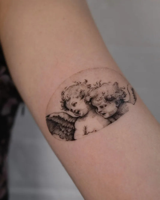 Small Blackwork Cherub Tattoo on Women Arm by @blair_ding