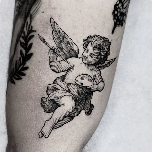 Small Blackwork Cherub with Paintbrush Tattoo on Women Arm by @_donbraga
