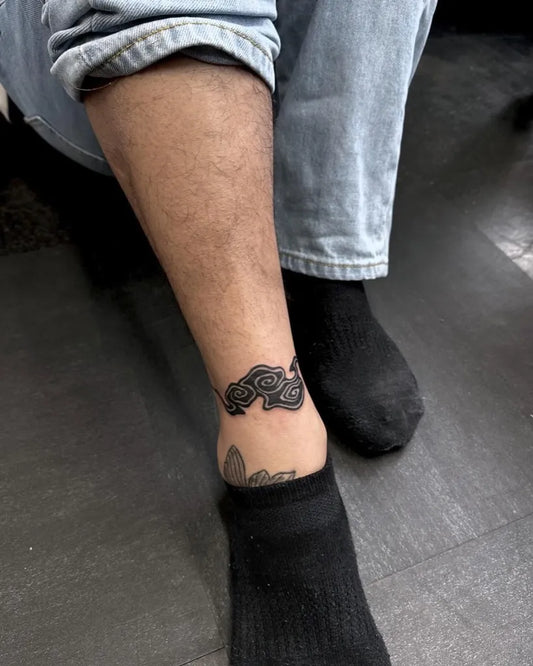 Small Blackwork Cloud Tattoo on Men Ankle by @chikage8