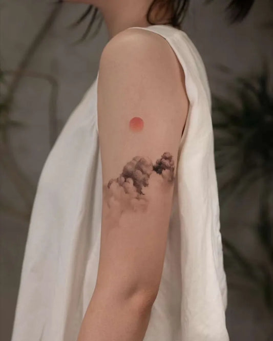 Small Blackwork Cloud and Mountain Tattoo on Women Shoulder by @newtattoo_studio
