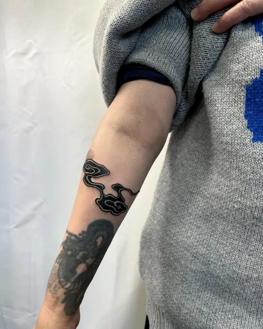 Small Blackwork Cloud and Snakes Tattoo on Women Arm by @chikage8