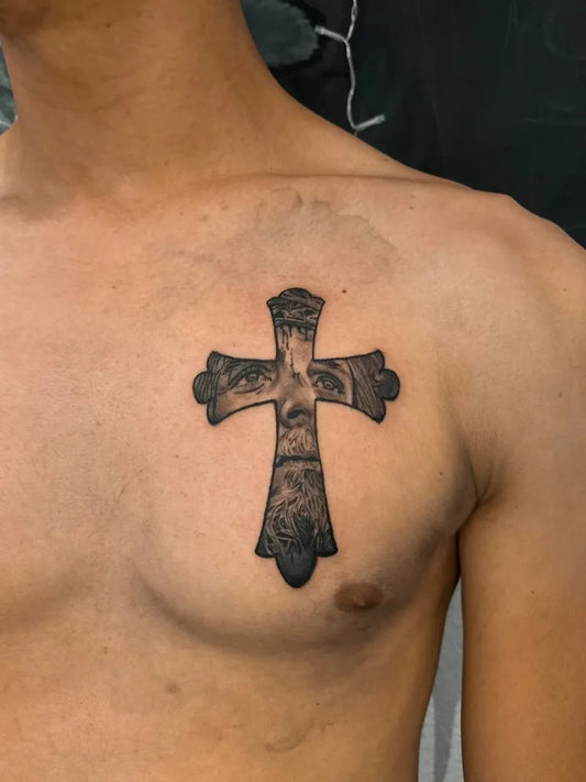 Small Blackwork Cross with Eyes on Men Chest Religious Tattoo by @tattooin_studio