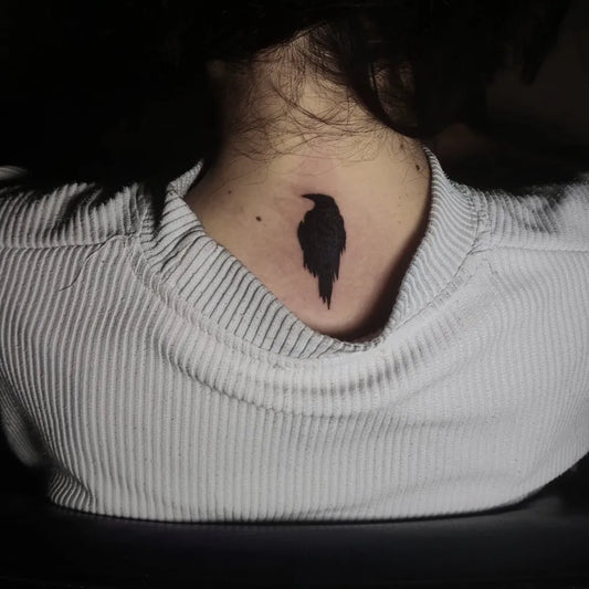 Small Blackwork Crow Tattoo on Women Nape by @tattoo.sumqayit