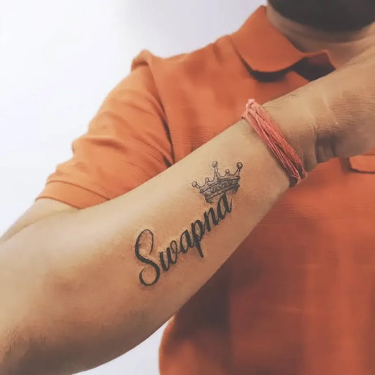 Small Blackwork Crown Name Tattoo on Men Forearm by @actiontattoopune