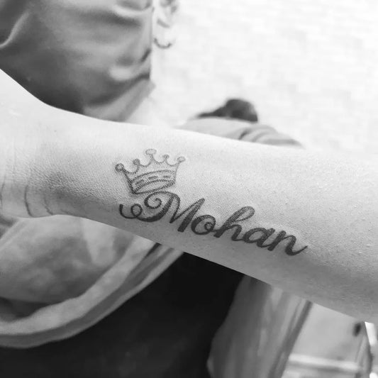 Small Blackwork Crown Name Tattoo on Women Wrist by @angel_tattoo_studio__