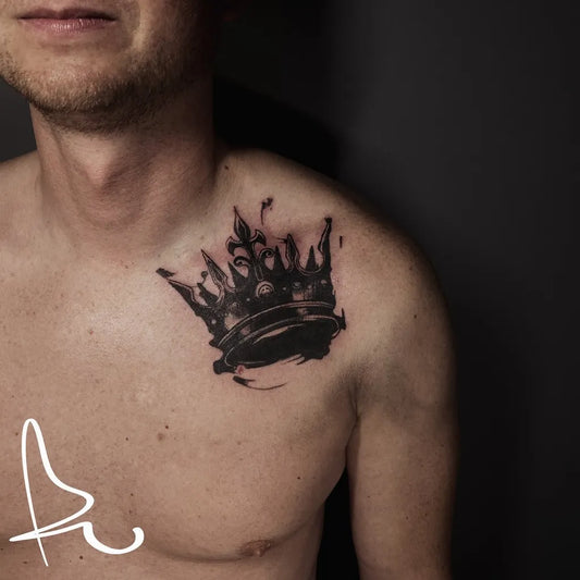 Small Blackwork Crown Tattoo on Men Shoulder by @rarski_tattoo