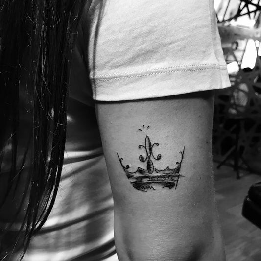 Small Blackwork Crown Tattoo on Women Arm by @cesaritual