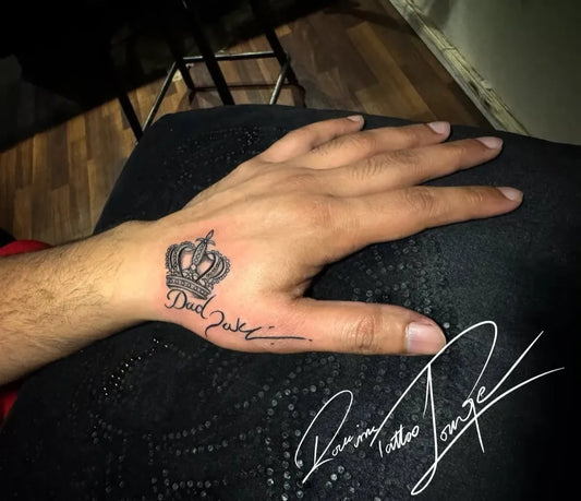 Small Blackwork Crown and Writing Tattoo on Men Hand by @rockinktattoolounge