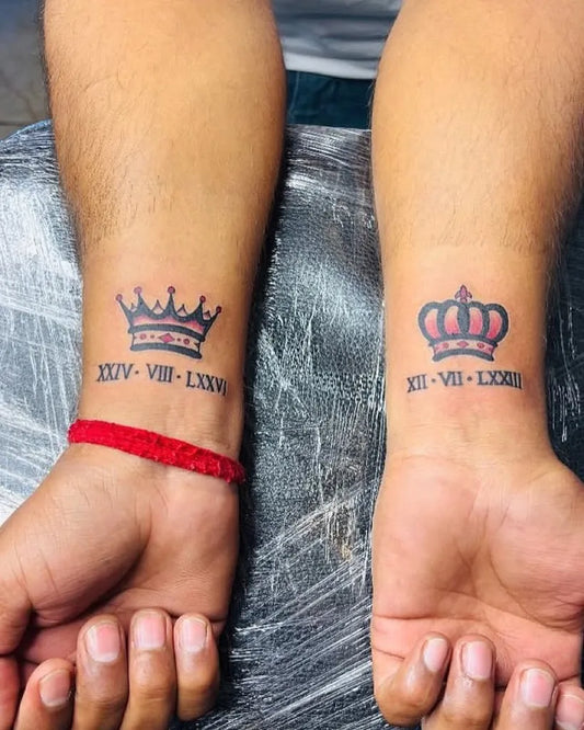 Small Blackwork Crown with Roman Numerals Tattoo on Men Wrist by @dalwi_tattoo_zone
