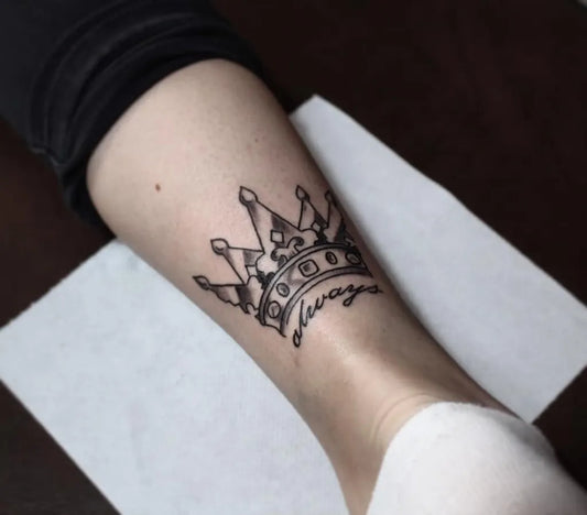 Small Blackwork Crown with Sempre Tattoo on Women Leg by @she_is_baby_blue