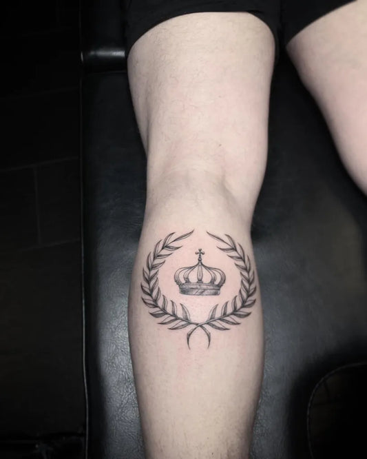 Small Blackwork Crowned Laurel Tattoo on Women Knee by @wickedlotz