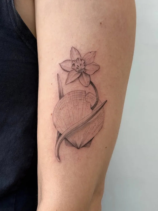 Small Blackwork Daffodil and Seashell Tattoo on Women Arm by @deecarl