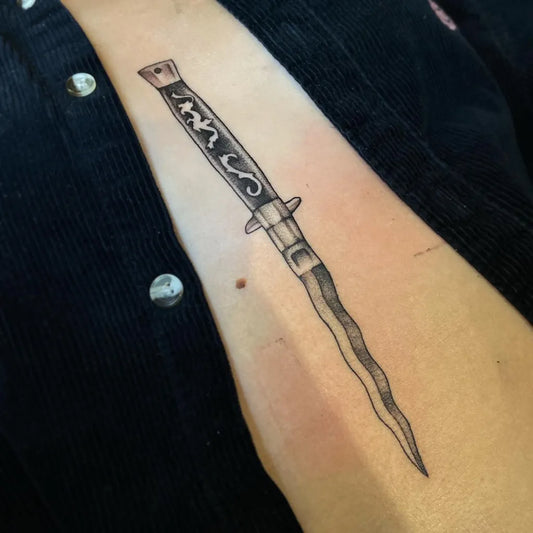 Small Blackwork Dagger on Women Sternum Tattoo by @ericacyrtattoos