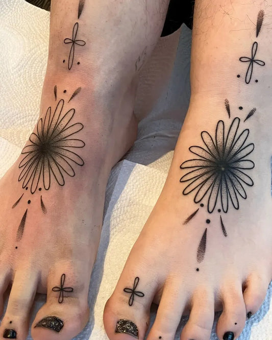 Small Blackwork Daisy and Cross Tattoo on Women Foot by @phoebe.collins